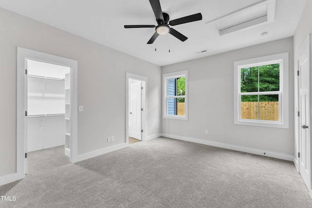 405 N Raiford St, Selma, NC 27576 - unfurnished bedroom with carpet flooring, attic access, a walk in closet, baseboards, and a closet