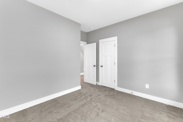 405 N Raiford St, Selma, NC 27576 - unfurnished bedroom with carpet and baseboards