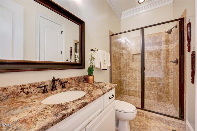 bathroom featuring vanity, ornamental molding, a stall shower, and toilet