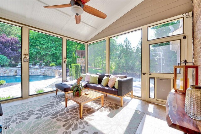 sunroom / solarium with tile patterned flooring and lofted ceiling