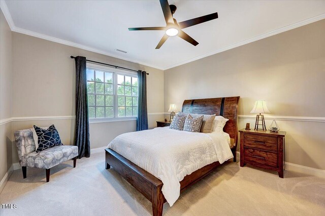 carpeted bedroom with baseboards, ornamental molding, a ceiling fan, and visible vents