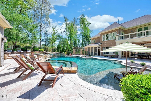 view of pool featuring a patio and a pool with connected hot tub