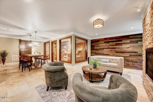 living room featuring crown molding, baseboards, wooden walls, and visible vents