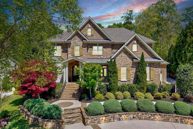 craftsman inspired home with brick siding, stairs, and stone siding