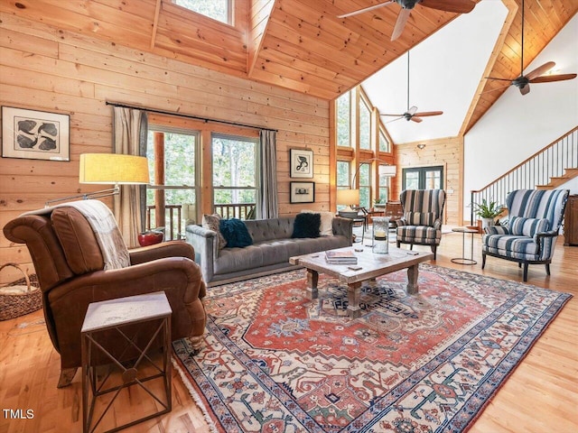 living room featuring a ceiling fan, high vaulted ceiling, and a healthy amount of sunlight