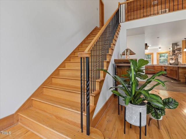 stairs featuring wood finished floors