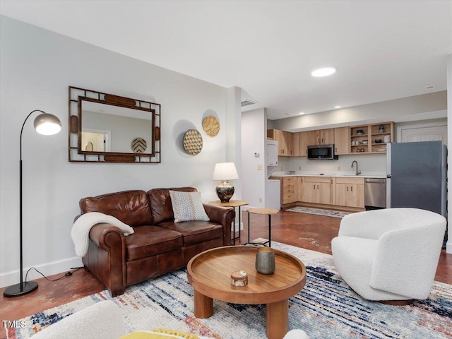 living area with baseboards, recessed lighting, finished concrete flooring, and visible vents