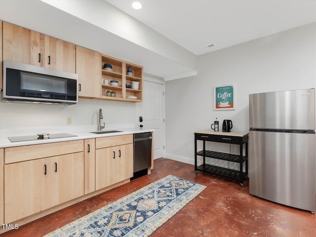 kitchen featuring light brown cabinets, light countertops, finished concrete floors, a sink, and appliances with stainless steel finishes