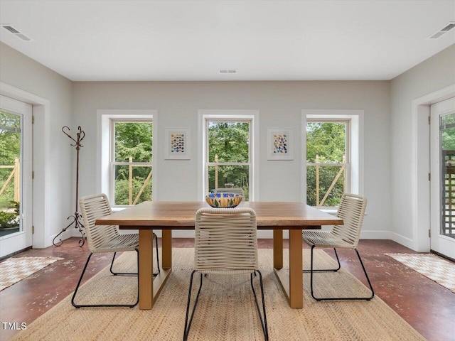 dining space with concrete flooring, visible vents, and a wealth of natural light