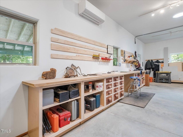 interior space with a workshop area and an AC wall unit