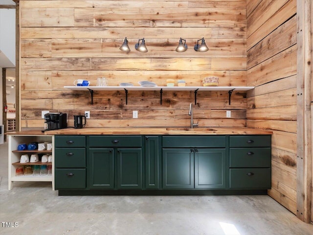 bar featuring a sink, concrete flooring, and wood walls