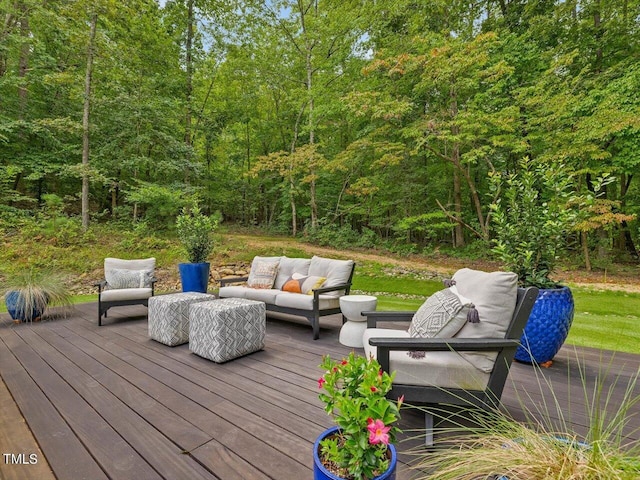 deck with a view of trees and outdoor lounge area