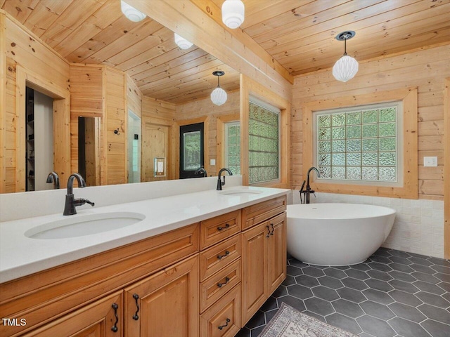 full bathroom with wood ceiling, wood walls, a wealth of natural light, and a sink