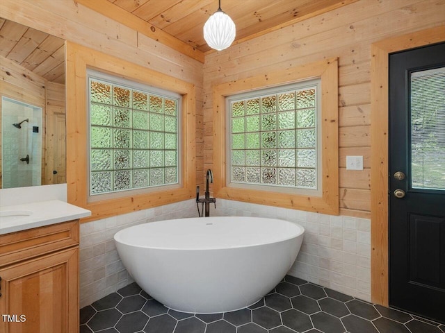bathroom with tile patterned flooring, vanity, a freestanding tub, wooden ceiling, and a stall shower