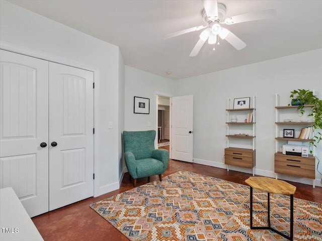 sitting room with a ceiling fan and baseboards