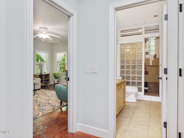 bathroom featuring a ceiling fan, toilet, baseboards, and vanity