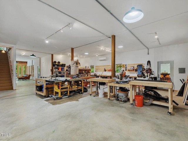 garage with a workshop area and a wall mounted air conditioner