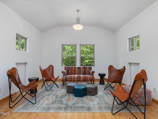 sitting room featuring vaulted ceiling and hardwood / wood-style floors