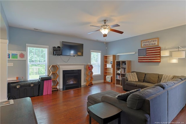 508 Stonebriar Ave, Raeford, NC 28376 - living area featuring a ceiling fan, dark wood-style floors, a fireplace with flush hearth, and baseboards