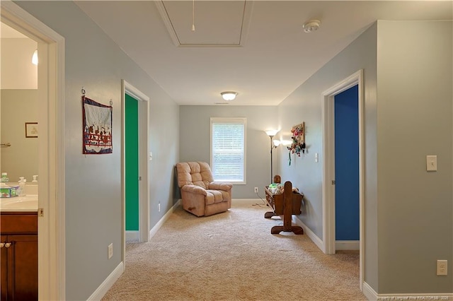 living area with light carpet and baseboards