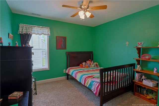 carpeted bedroom featuring a ceiling fan and baseboards