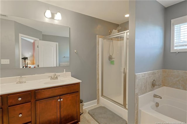 full bathroom featuring vanity, a stall shower, a garden tub, and tile patterned floors