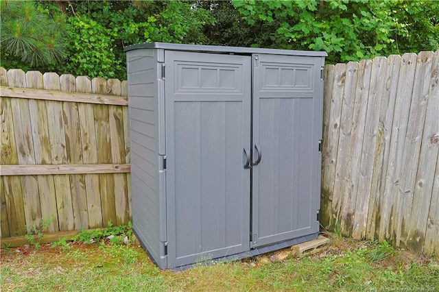 view of shed featuring fence