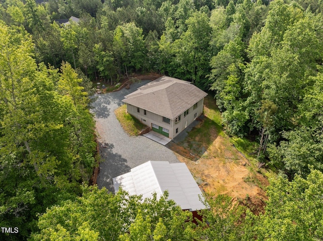 view of subject property featuring a heavily wooded area