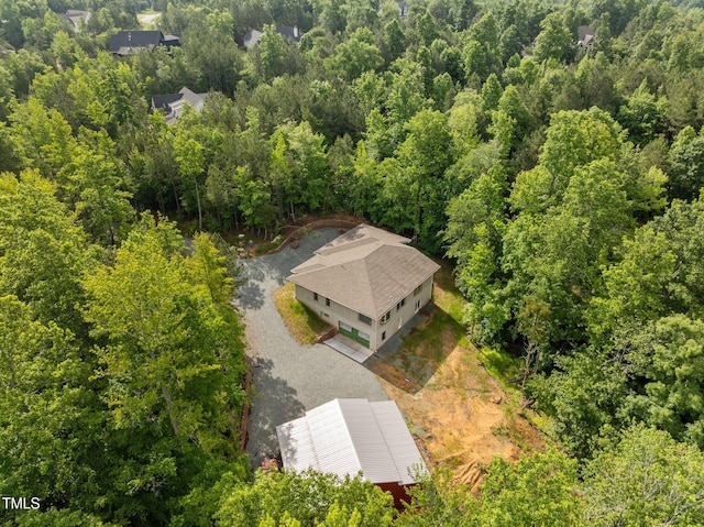 view from above of property featuring a heavily wooded area