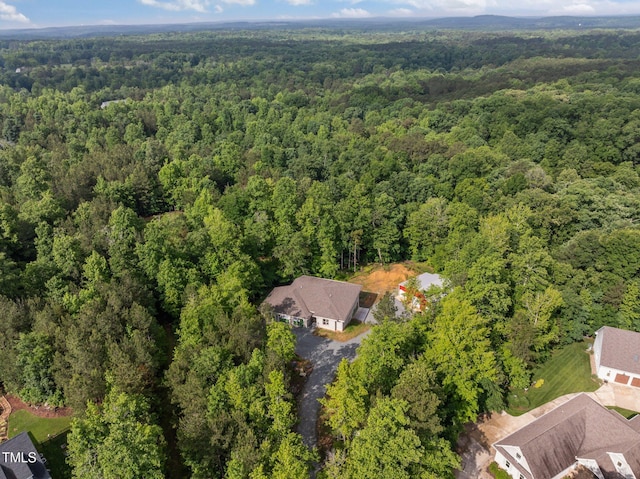 aerial overview of property's location with a heavily wooded area