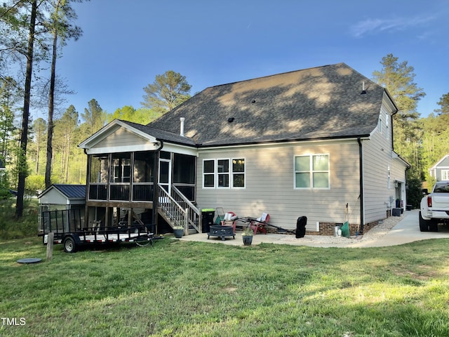 175 Lockamy Ln, Youngsville, NC 27596 - back of property featuring a sunroom, a shingled roof, a yard, and a patio area