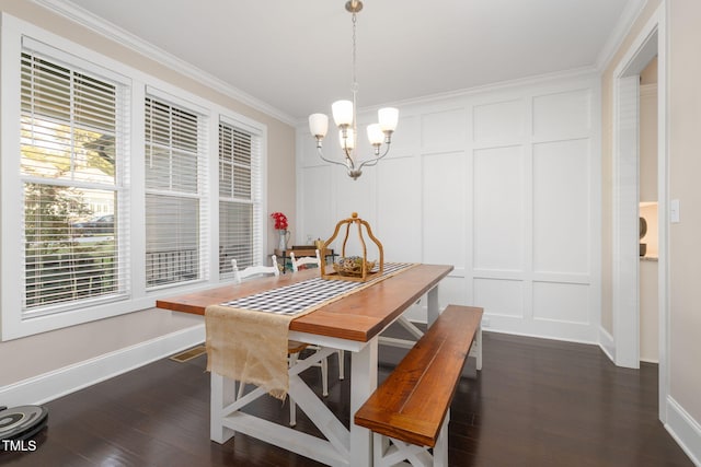175 Lockamy Ln, Youngsville, NC 27596 - dining area with a decorative wall, crown molding, a chandelier, dark wood-style floors, and baseboards