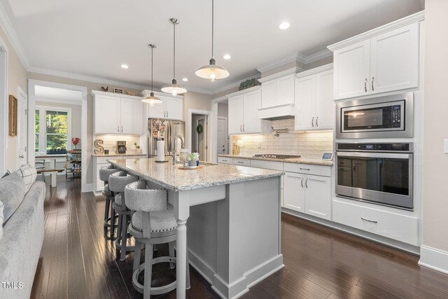 175 Lockamy Ln, Youngsville, NC 27596 - kitchen featuring stainless steel appliances, a sink, white cabinets, backsplash, and ornamental molding