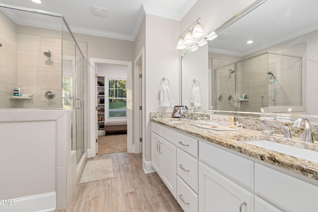 175 Lockamy Ln, Youngsville, NC 27596 - bathroom featuring a stall shower, wood finished floors, double vanity, recessed lighting, and ornamental molding