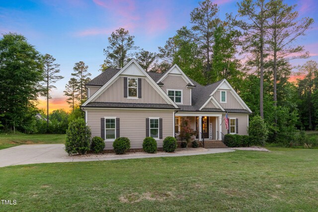 175 Lockamy Ln, Youngsville, NC 27596 - craftsman-style house with a porch, board and batten siding, and a lawn