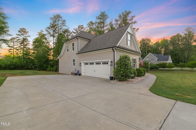 175 Lockamy Ln, Youngsville, NC 27596 - property exterior at dusk featuring concrete driveway, a lawn, a garage, board and batten siding, and a shingled roof