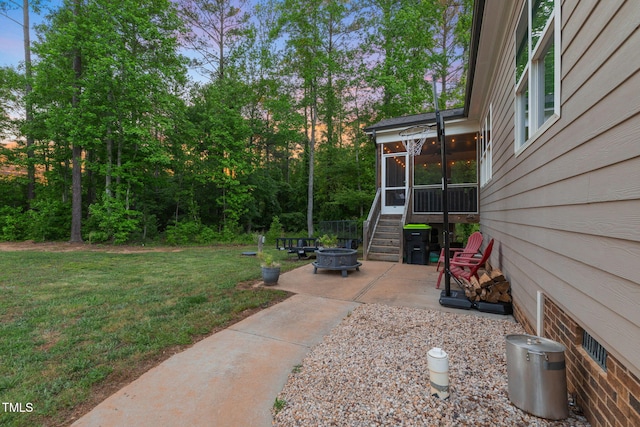 175 Lockamy Ln, Youngsville, NC 27596 - view of grassy yard with a fire pit, a sunroom, and a patio area