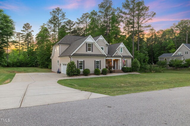 175 Lockamy Ln, Youngsville, NC 27596 - craftsman-style house with driveway, a garage, board and batten siding, a yard, and covered porch