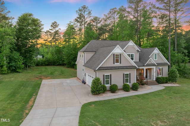 175 Lockamy Ln, Youngsville, NC 27596 - view of front facade featuring board and batten siding, driveway, a garage, covered porch, and a front yard