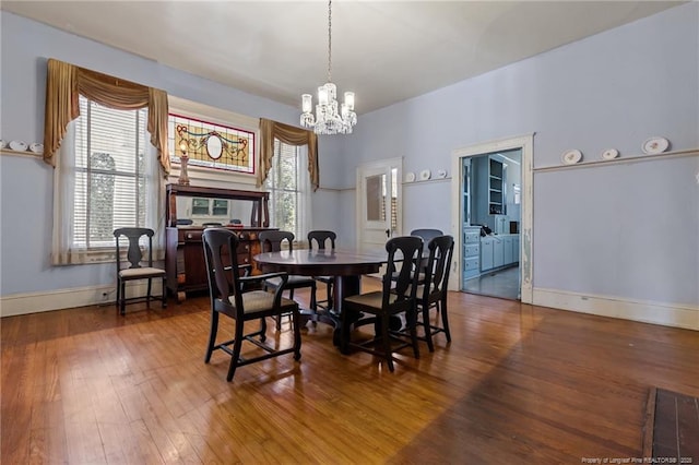 205 N Vance St, Pembroke, NC 28377 - dining area with a notable chandelier, a wealth of natural light, and wood finished floors