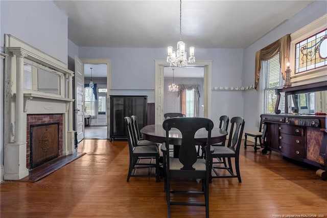 205 N Vance St, Pembroke, NC 28377 - dining area with a fireplace, wood finished floors, and a notable chandelier