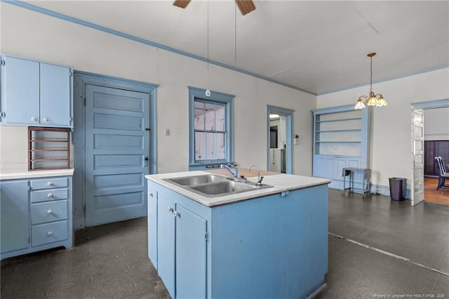 205 N Vance St, Pembroke, NC 28377 - kitchen featuring a sink, a ceiling fan, light countertops, blue cabinets, and an island with sink