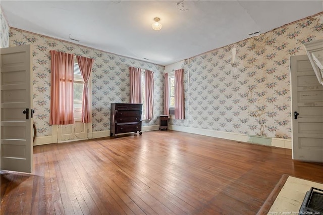 205 N Vance St, Pembroke, NC 28377 - interior space featuring baseboards, wallpapered walls, and wood-type flooring