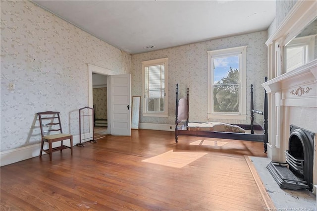 205 N Vance St, Pembroke, NC 28377 - sitting room with wood finished floors, wallpapered walls, and baseboards