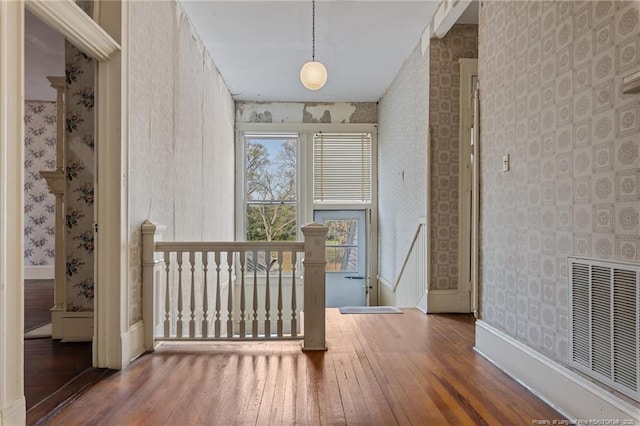 205 N Vance St, Pembroke, NC 28377 - interior space featuring visible vents, wallpapered walls, and hardwood / wood-style flooring