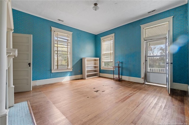 205 N Vance St, Pembroke, NC 28377 - unfurnished room featuring crown molding, visible vents, hardwood / wood-style floors, and baseboards