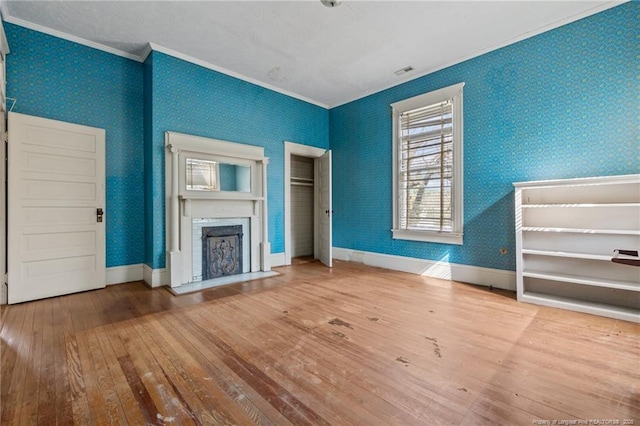 205 N Vance St, Pembroke, NC 28377 - unfurnished living room featuring a fireplace, wood-type flooring, baseboards, ornamental molding, and wallpapered walls