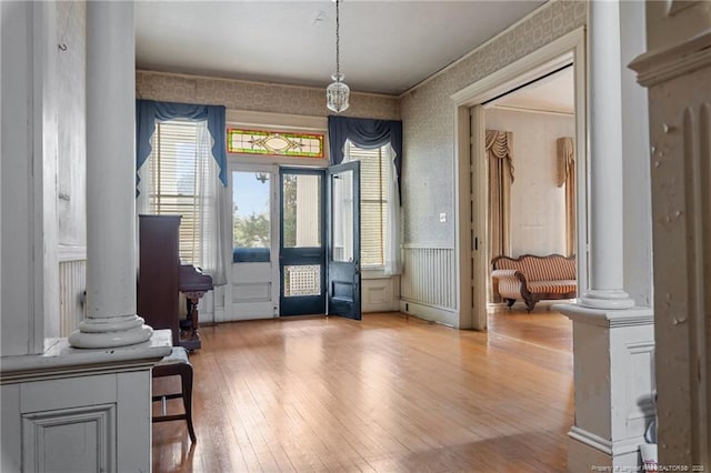 205 N Vance St, Pembroke, NC 28377 - entryway featuring light wood-style floors, wallpapered walls, and decorative columns