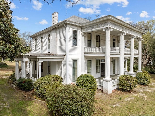 205 N Vance St, Pembroke, NC 28377 - view of property exterior featuring a chimney, a porch, and a balcony