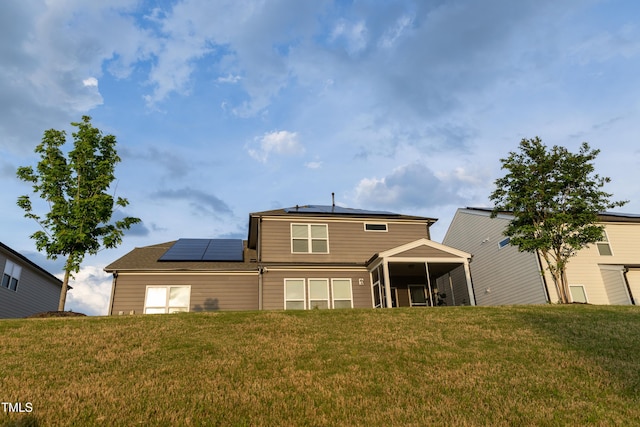 428 Parlier Dr, Apex, NC 27523 - rear view of property with a sunroom, a lawn, and solar panels